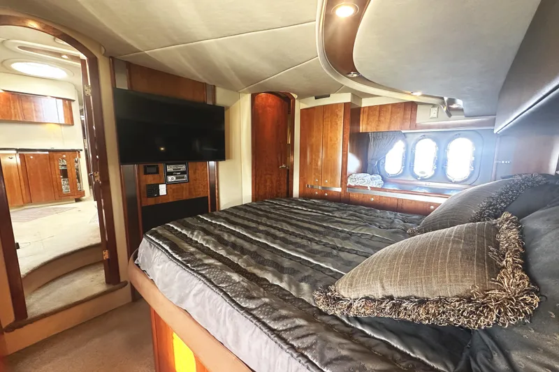 Slide: The Image of Luxurious 2007 Cruisers Yachts 540 Express bedroom with elegant wood finishes and modern amenities. - 36