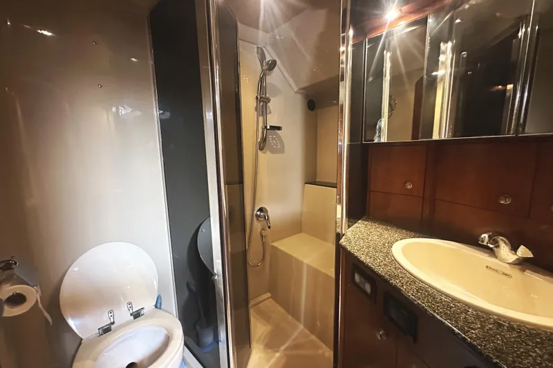 Slide: The Image of Luxurious bathroom in 2007 Cruisers Yachts 540 Express, featuring shower, sink, and toilet. - 44