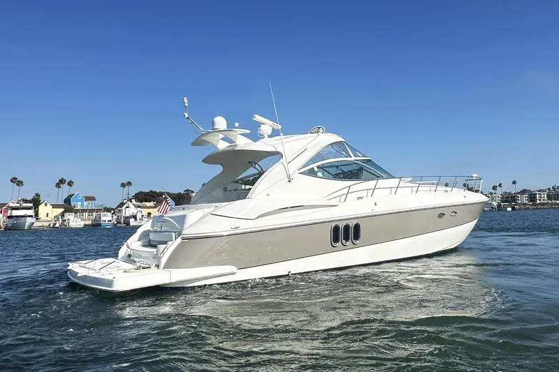 Slide: The Image of 2007 Cruisers Yachts 540 Express on water, clear sky, coastal background. - 5