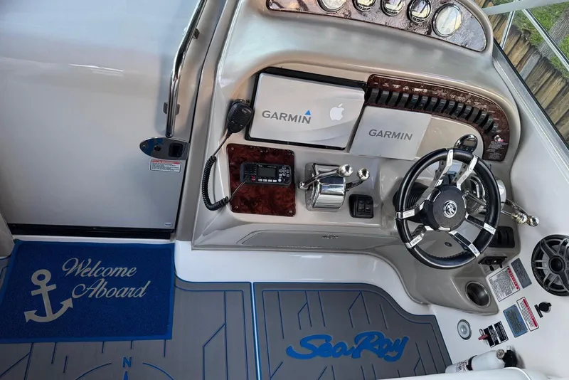 Slide: The Image of Interior of 2006 Sea Ray 290 Amberjack with TV, seating, and blue lighting. - 12