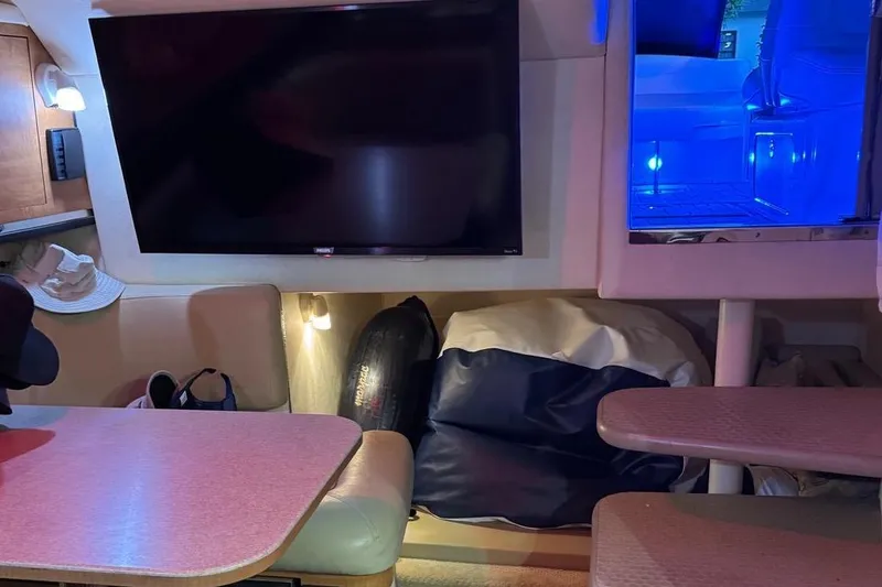 Slide: The Image of Luxurious 2006 Sea Ray 290 Amberjack cabin with red lighting and striped bedding. - 15