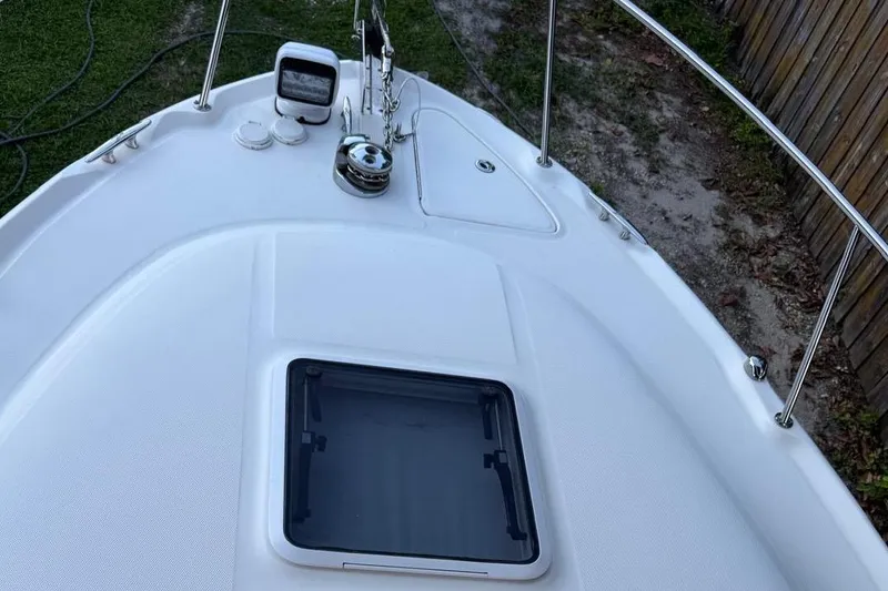 Slide: The Image of 2006 Sea Ray 290 Amberjack boat with black cover, docked in a residential area. - 21