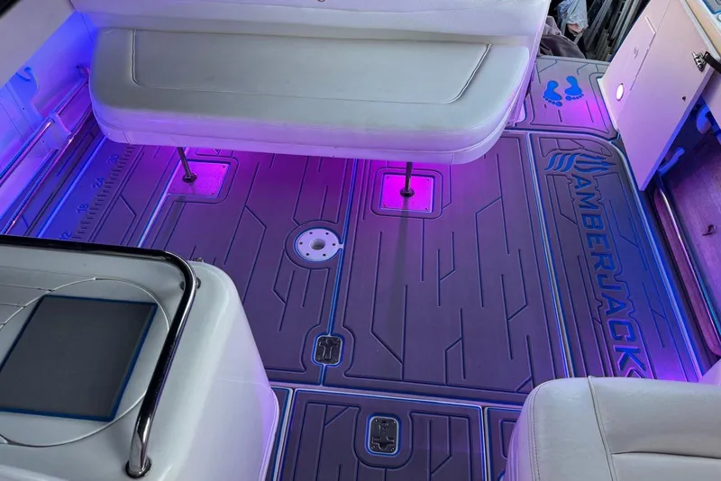 Slide: The Image of 2006 Sea Ray 290 Amberjack interior with blue LED lighting and cockpit seating. - 8