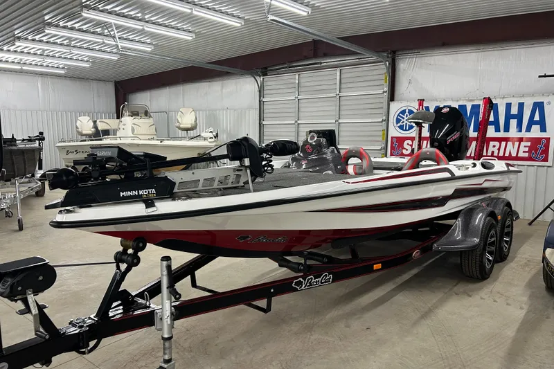 Slide: The Image of 2023 Bass Cat Eyra boat in showroom, featuring Minn Kota Ultrex motor. - 1