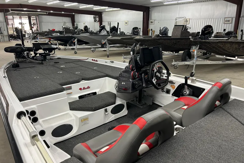 Slide: The Image of 2023 Bass Cat Eyra boat interior with modern dashboard and seating in showroom. - 5