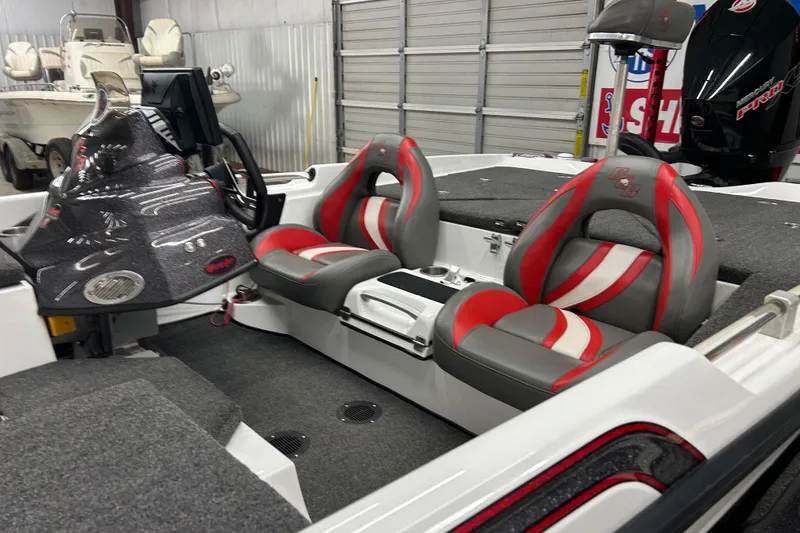 Slide: The Image of 2023 Bass Cat Eyra boat interior with red and gray seats, modern dashboard, and spacious layout. - 6