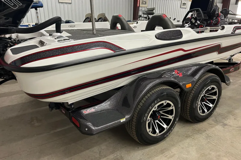 Slide: The Image of 2023 Bass Cat Eyra boat on trailer, featuring sleek design and dual wheels. - 7