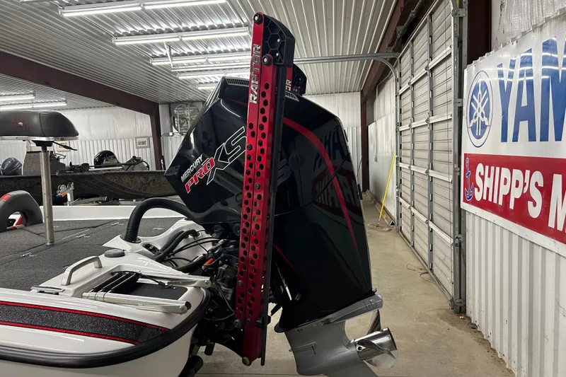 Slide: The Image of 2023 Bass Cat Eyra boat with Mercury Pro XS engine in a garage setting. - 9