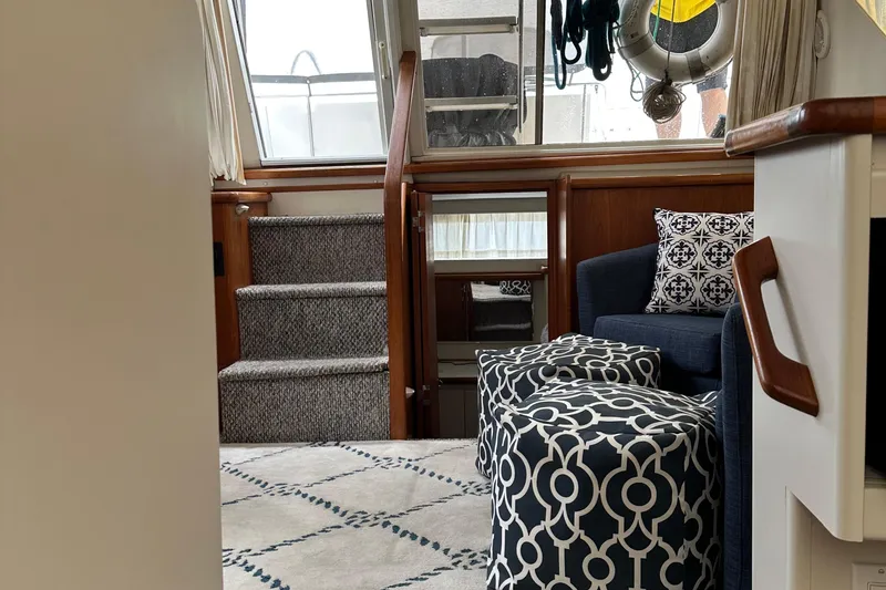 Slide: The Image of Interior of 1995 Carver 325 Aft Cabin with stairs, seating, and patterned decor. - 10