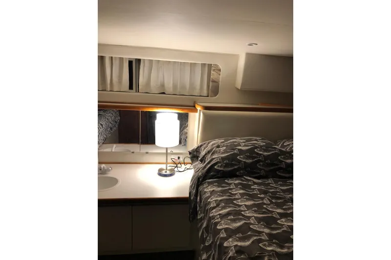 Slide: The Image of Cozy cabin interior of 1995 Carver 325 Aft Cabin with bed and lamp. - 11