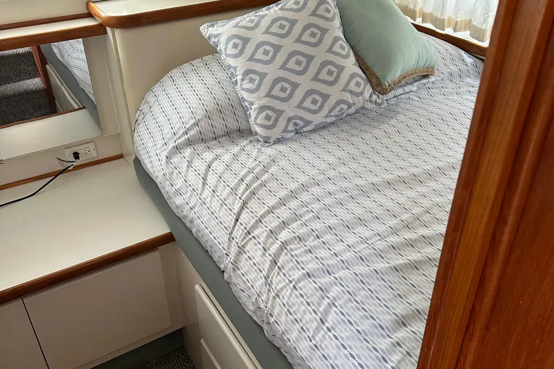 Slide: The Image of Cozy bedroom in 1995 Carver 325 Aft Cabin with patterned bedding and pillows. - 12
