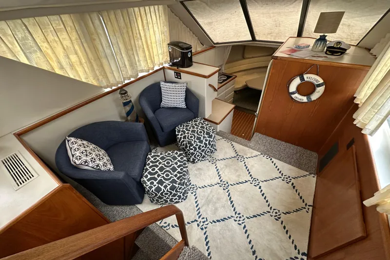Slide: The Image of Interior of 1995 Carver 325 Aft Cabin with cozy seating and nautical decor. - 14