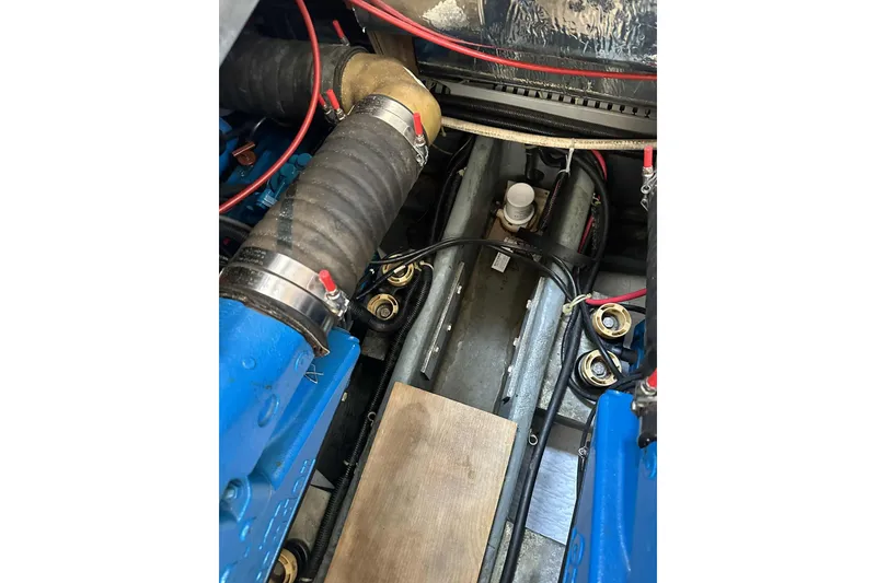 Slide: The Image of Engine compartment of a 1995 Carver 325 Aft Cabin boat, showing hoses and wiring. - 17