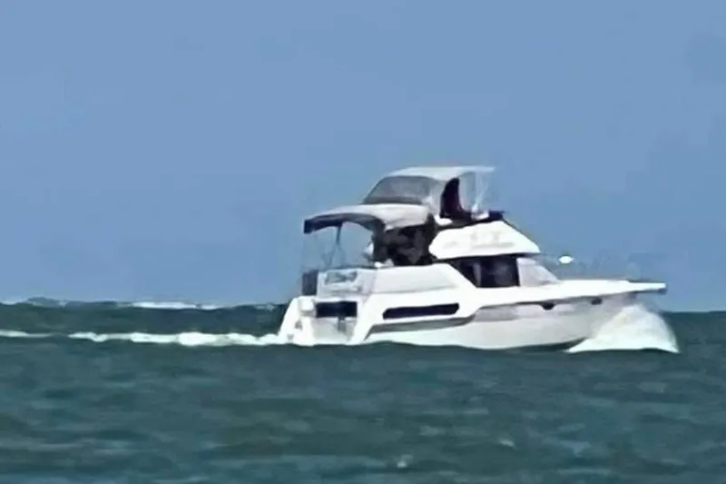 Slide: The Image of 1995 Carver 325 Aft Cabin cruising on open water under clear skies. - 3
