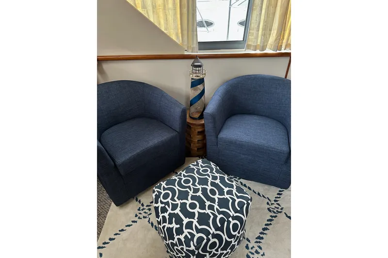 Slide: The Image of Two blue chairs and patterned ottoman in Carver 325 Aft Cabin, 1995 model. - 5