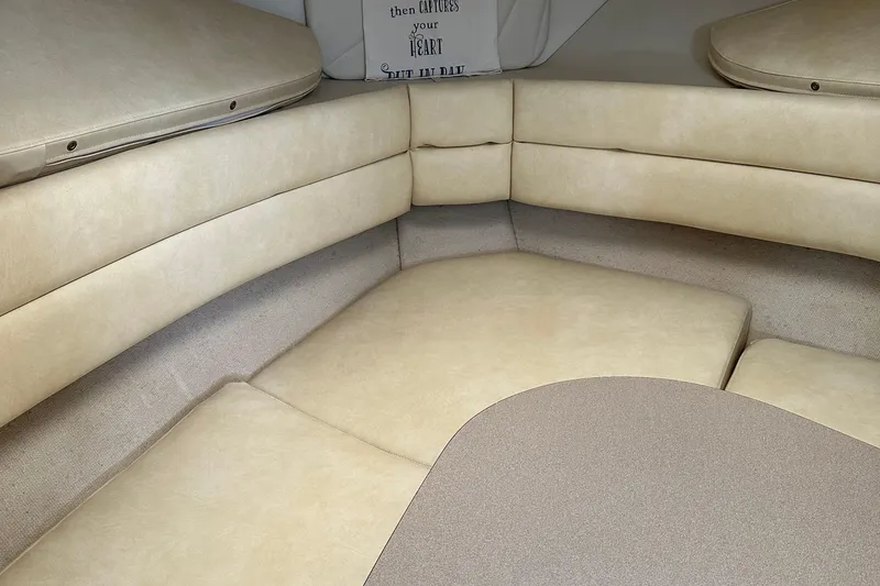 Slide: The Image of Interior of 1995 Carver 325 Aft Cabin with beige seating and cushions. - 7
