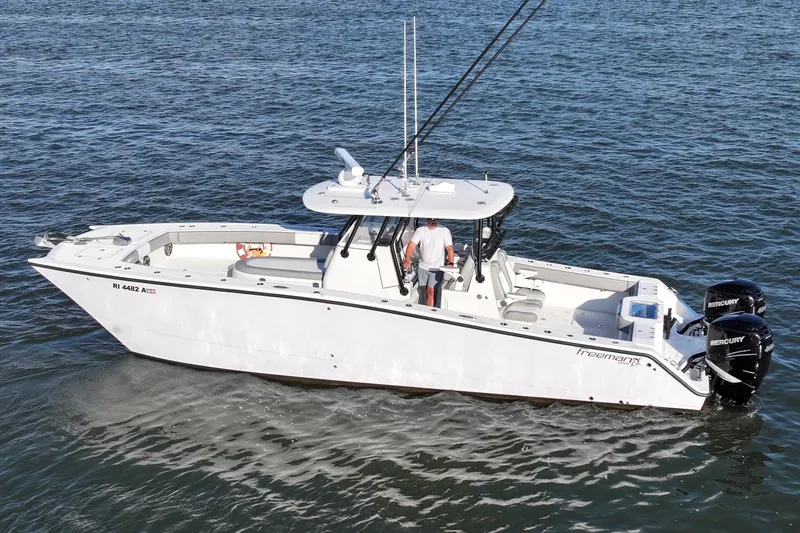 Slide: The Image of 2020 Freeman 34VH boat on water with dual Mercury engines. - 11