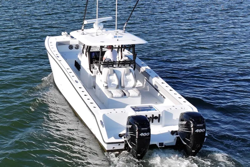 Slide: The Image of Freeman 34VH 2020 boat cruising on open water with twin Mercury engines. - 13