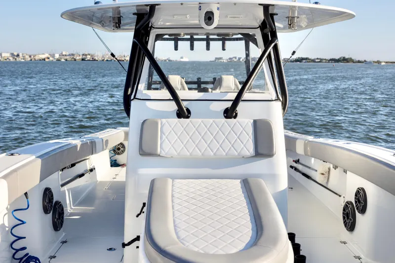 Slide: The Image of 2020 Freeman 34VH boat interior with cushioned seating, on open water. - 14