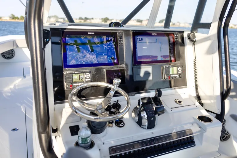 Slide: The Image of Control panel of a 2020 Freeman 34VH boat with navigation screens and steering wheel. - 15