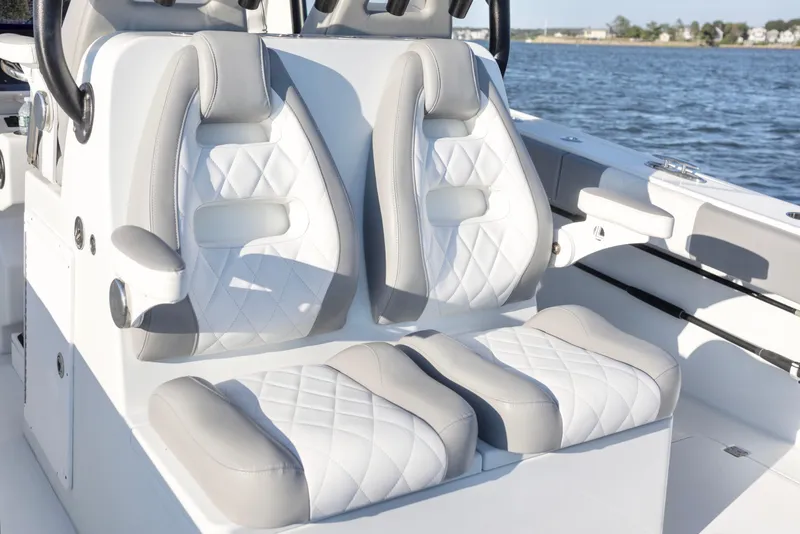 Slide: The Image of Luxurious seating on a 2020 Freeman 34VH boat, featuring white and gray cushioned seats. - 16