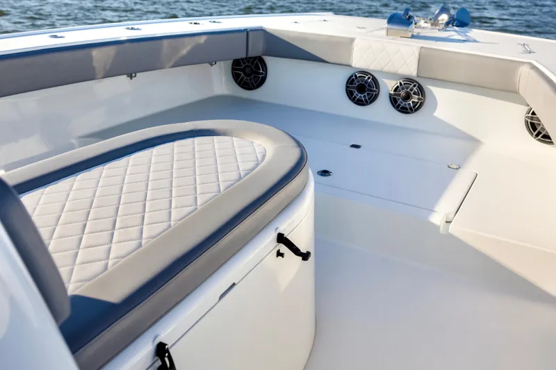 Slide: The Image of Luxurious seating area on a 2020 Freeman 34VH boat, featuring quilted upholstery and marine speakers. - 18