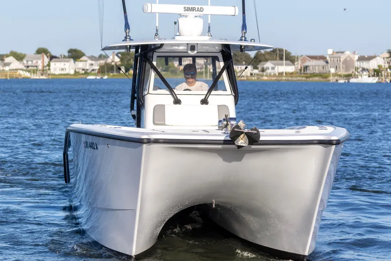 Slide: The Image of 2020 Freeman 34VH boat cruising on a calm lake near residential area. - 5