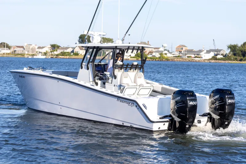 Slide: The Image of 2020 Freeman 34VH boat with twin Mercury 400 engines on a calm waterway. - 6