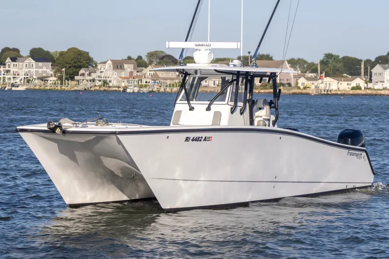 Slide: The Image of 2020 Freeman 34VH boat cruising on water near coastal homes. - 8