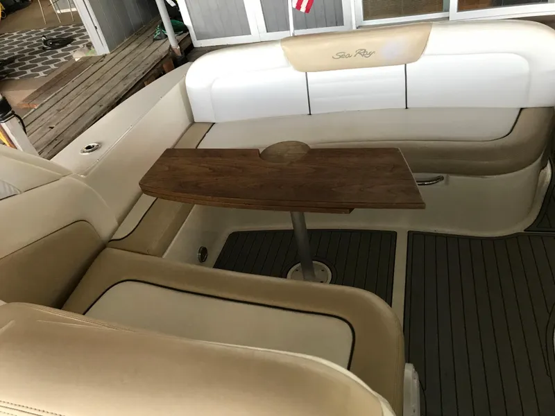 Slide: The Image of 2008 Sea Ray 330 Sundancer interior with beige seating and wooden table. - 14