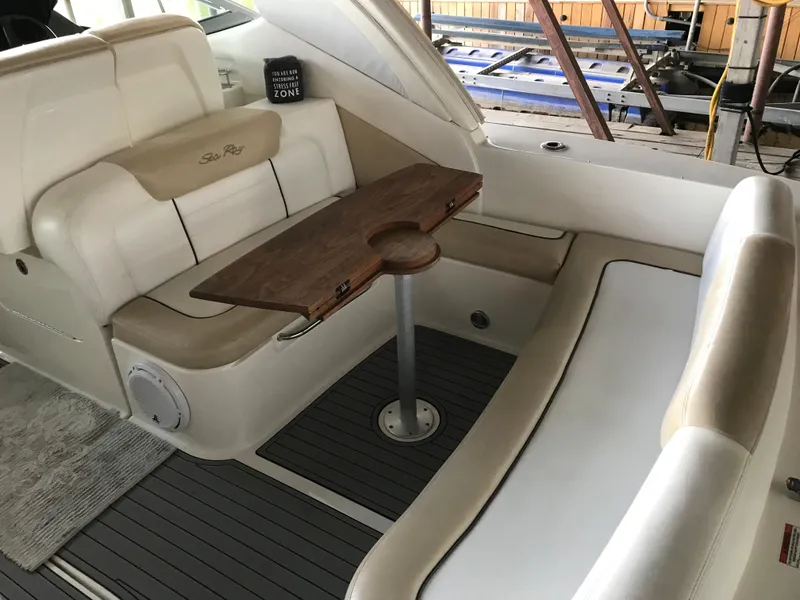 Slide: The Image of 2008 Sea Ray 330 Sundancer boat interior with seating and wooden table. - 16