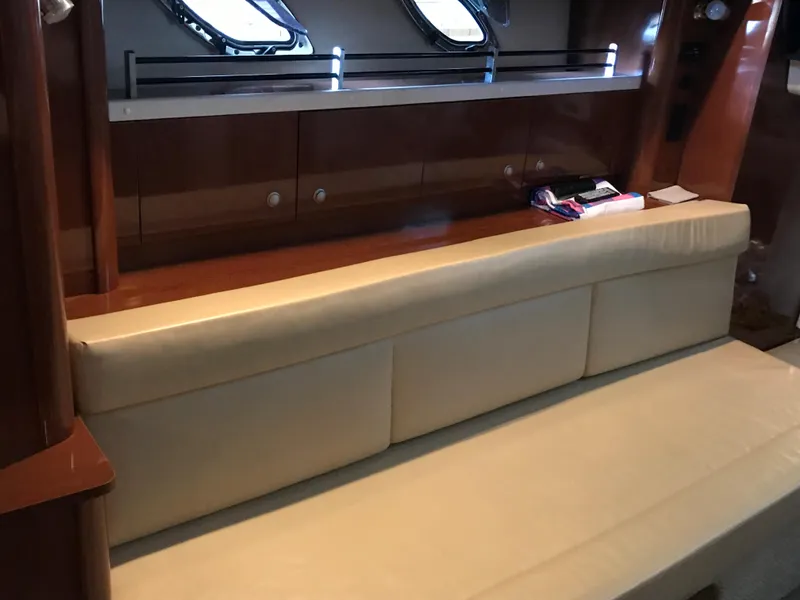 Slide: The Image of Interior of 2008 Sea Ray 330 Sundancer with beige seating and wooden cabinetry. - 18