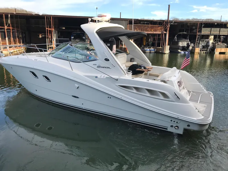 Slide: The Image of 2008 Sea Ray 330 Sundancer yacht docked in marina, American flag displayed. - 2