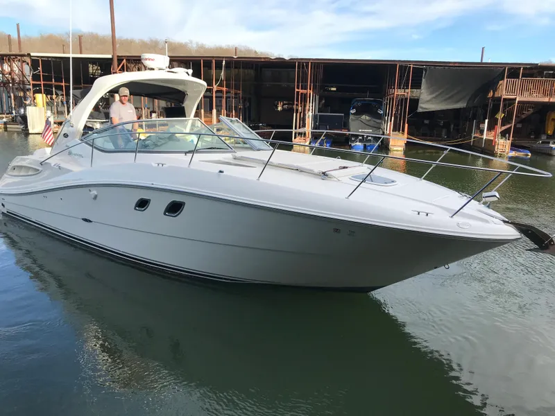 Slide: The Image of 2008 Sea Ray 330 Sundancer yacht docked in marina, calm water, clear sky. - 6