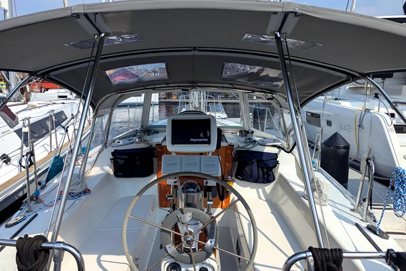 Slide: The Image of Cockpit of a 1995 Catalina 36 MkII sailboat with navigation equipment and steering wheel. - 11