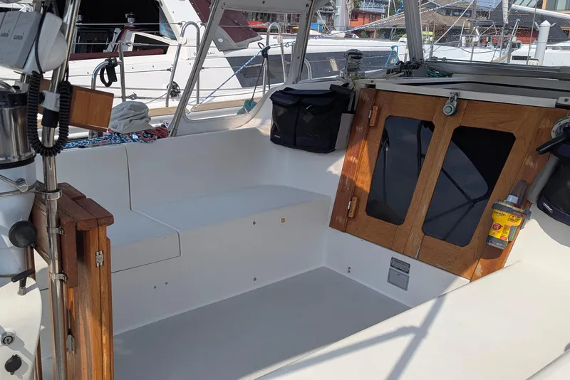 Slide: The Image of Cockpit of 1995 Catalina 36 MkII sailboat with wooden doors and seating area. - 12