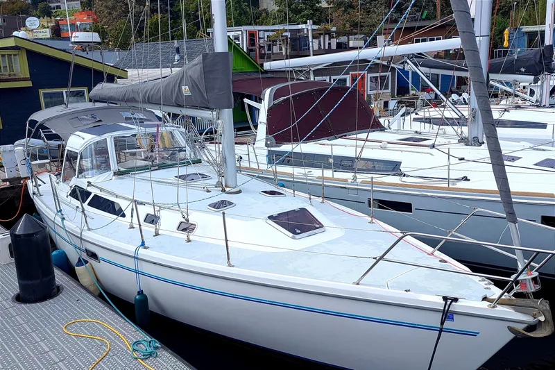 Slide: The Image of 1995 Catalina 36 MkII sailboat docked at marina, featuring sleek design and spacious deck. - 2