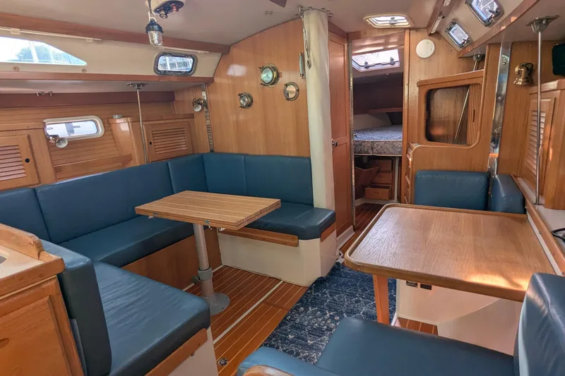 Slide: The Image of Interior of a 1995 Catalina 36 MkII sailboat with blue seating and wooden accents. - 20