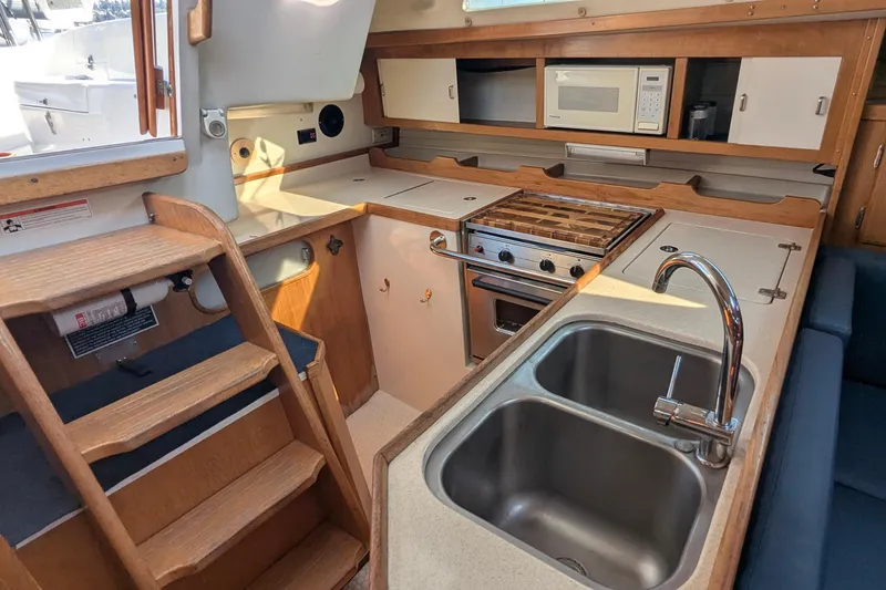 Slide: The Image of Interior of 1995 Catalina 36 MkII sailboat with kitchen and wooden stairs. - 23
