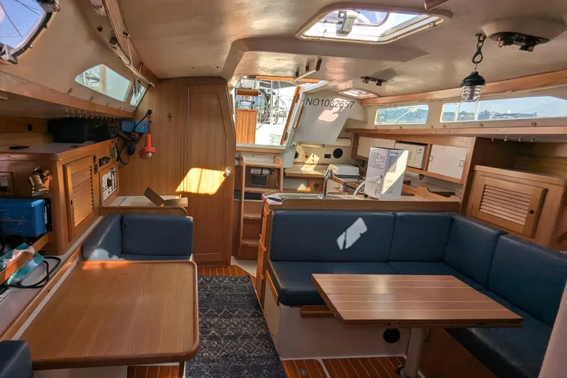 Slide: The Image of Interior of a 1995 Catalina 36 MkII sailboat with wood finishes and blue seating. - 27