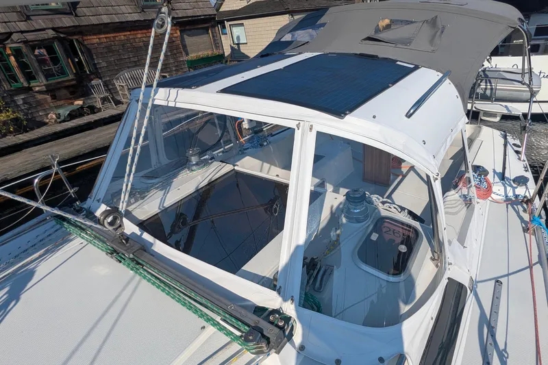 Slide: The Image of 1995 Catalina 36 MkII sailboat cockpit with solar panel and winches, docked at marina. - 3