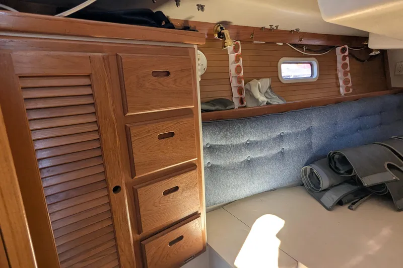 Slide: The Image of Interior of a 1995 Catalina 36 MkII sailboat with wooden cabinetry and blue upholstery. - 31