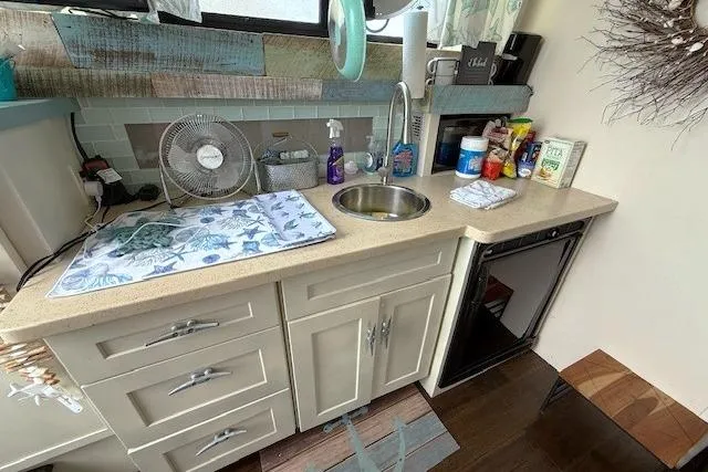 Slide: The Image of 1996 Mainship 31 Sedan Bridge kitchen with sink, fan, and countertop essentials. - 10