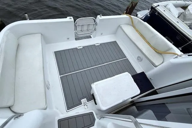 Slide: The Image of 1996 Mainship 31 Sedan Bridge boat deck with seating and storage compartments. - 3