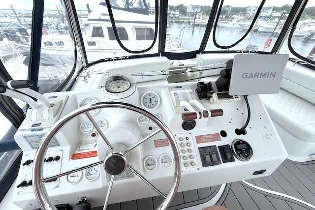 Slide: The Image of 1996 Mainship 31 Sedan Bridge helm with Garmin navigation, gauges, and steering wheel. - 4
