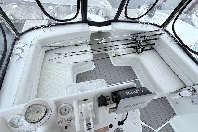 Slide: The Image of 1996 Mainship 31 Sedan Bridge cockpit with fishing rods and Garmin navigation system. - 5