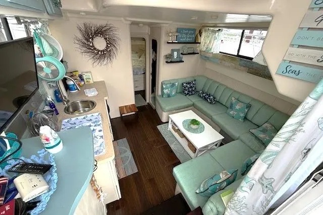 Slide: The Image of Interior of 1996 Mainship 31 Sedan Bridge with cozy seating and nautical decor. - 9