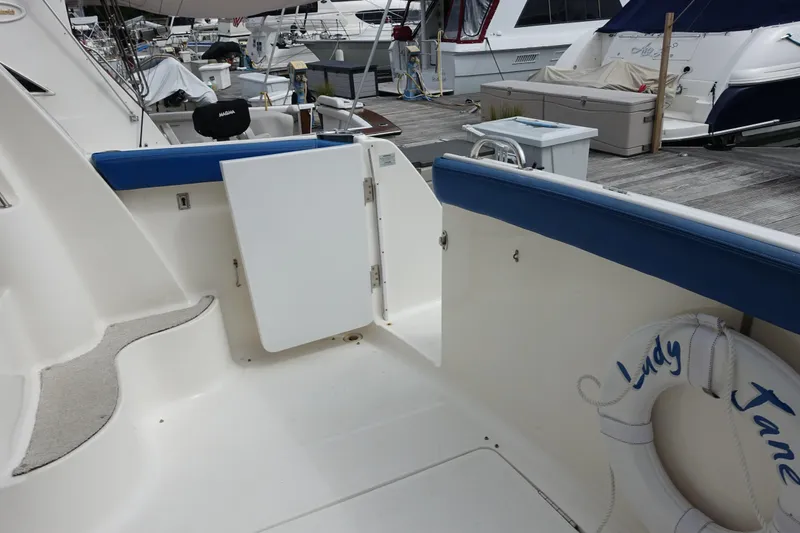 Slide: The Image of 2001 Silverton 410 Sport Bridge yacht deck with blue trim and life preserver. - 1