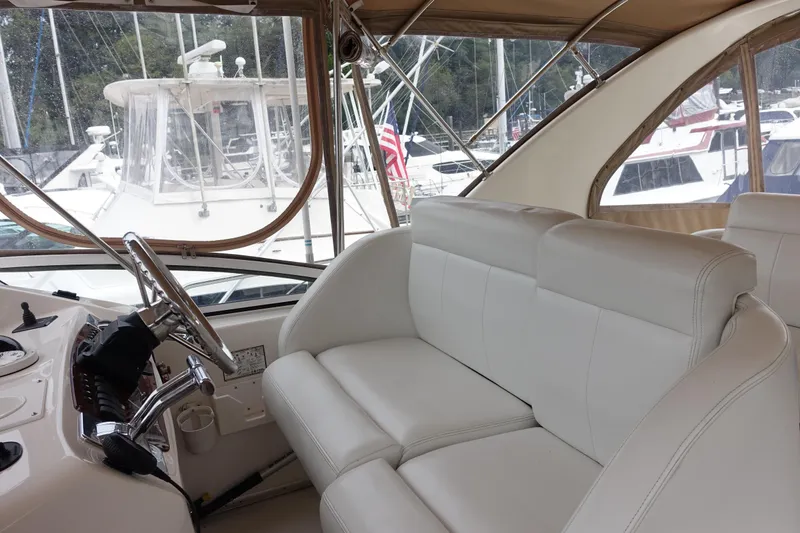 Slide: The Image of 2001 Silverton 410 Sport Bridge interior with white leather seating and steering wheel. - 12