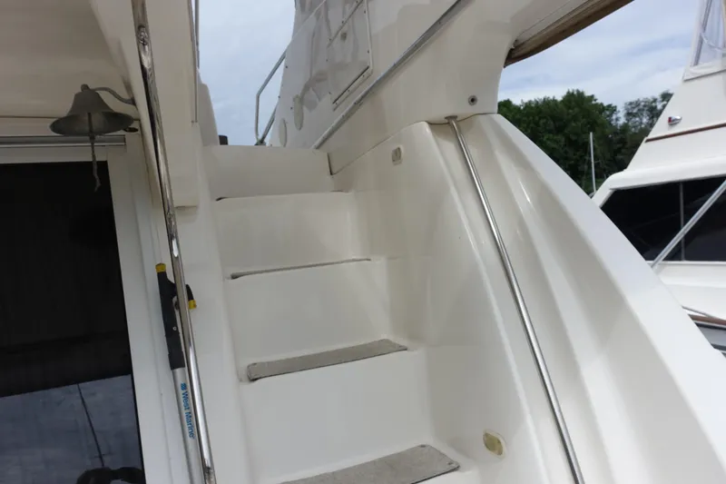 Slide: The Image of Staircase on 2001 Silverton 410 Sport Bridge yacht with bell and railing. - 16